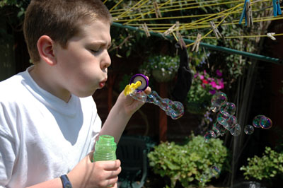 Boy blowing bubbles