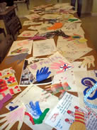 Hand print artwork laid out on a long table