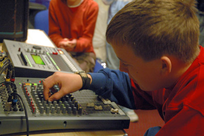Boy using a sound mixing desk