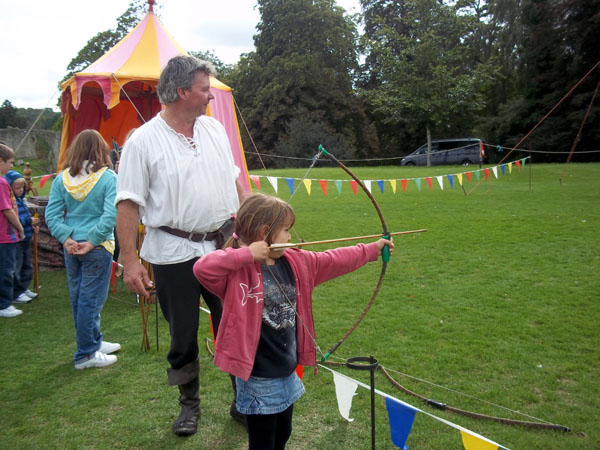 Young girl trying her hand at archery
